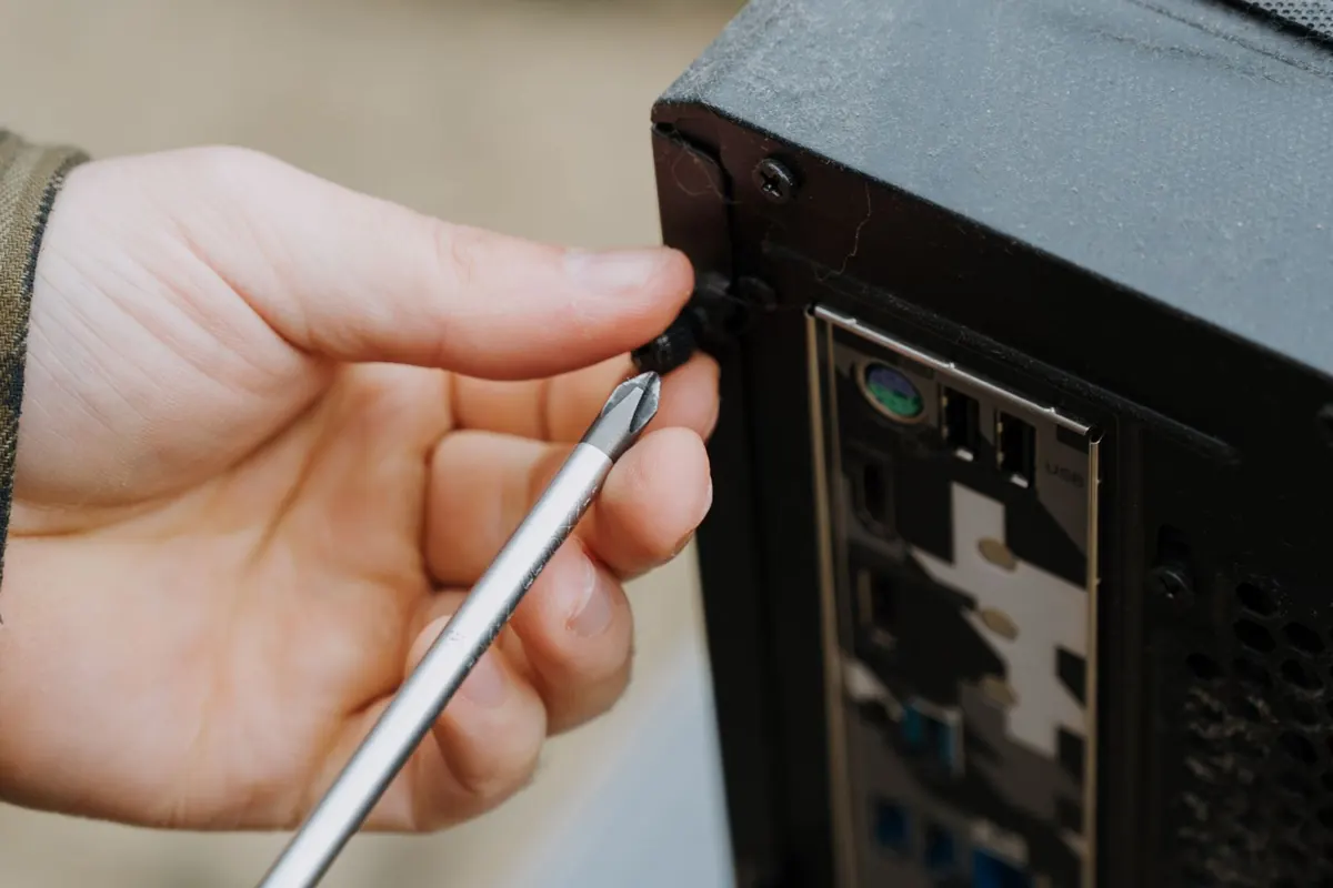PC desktop ricondizionati a Latina: intervento con il cacciavite sul retro del case durante la preparazione della macchina